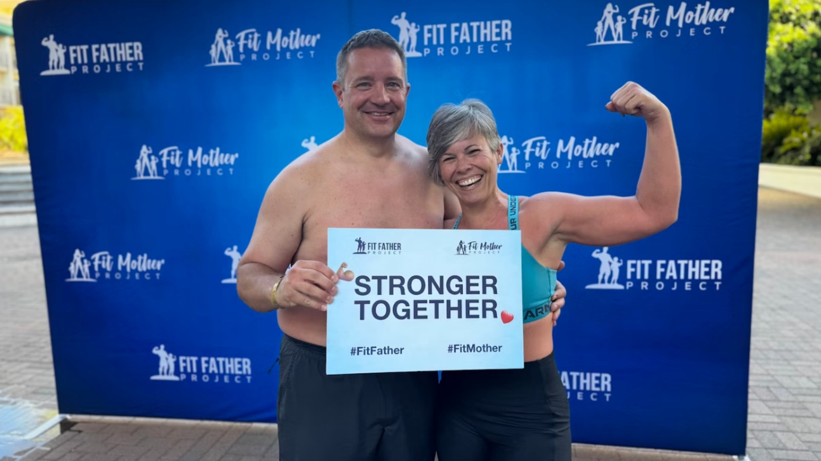 Brian and Renee Davis holding a Stronger Together sign at the 2025 event.